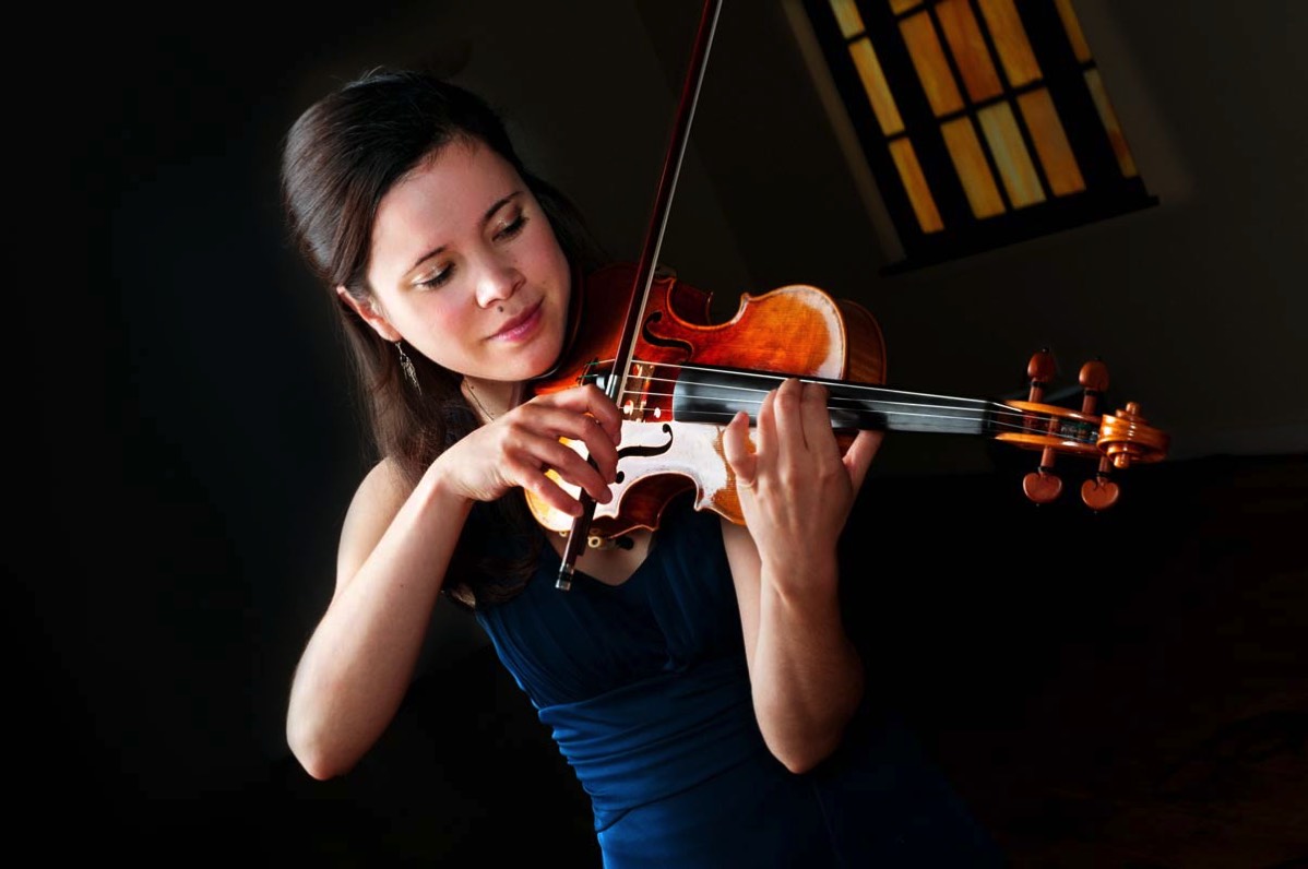 business portrait of young woman in blue dress playing violin